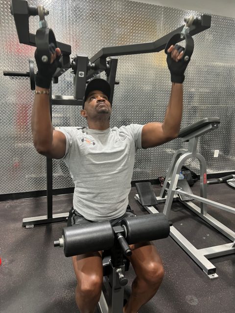 Man using a weight pull-down machine.
