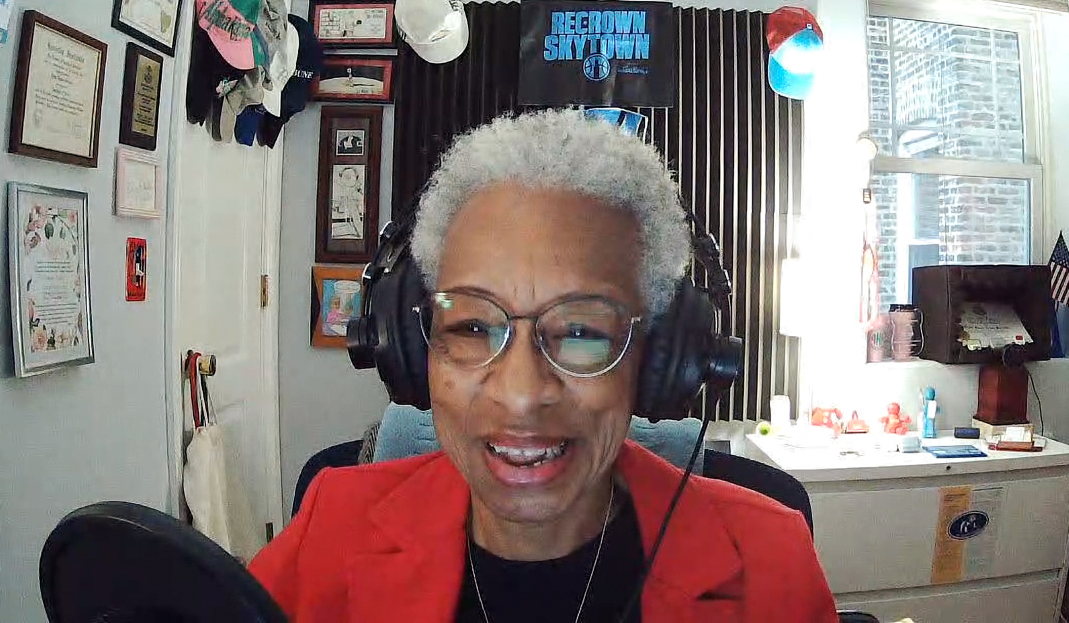 Podcast host Sheila Solomon at the microphone with headphones