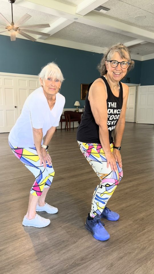 two senior women dancing Zumba and posing